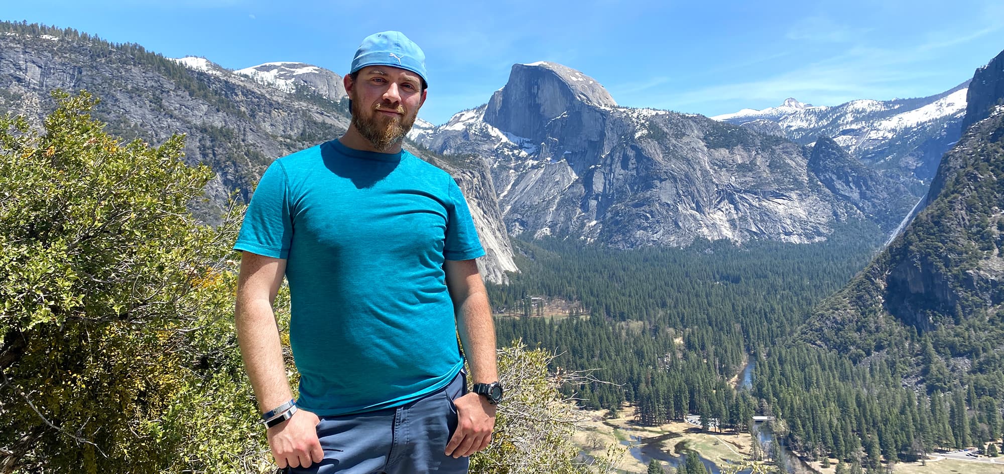 Ari Hiking in Yosemite with Half Dome Behind Him