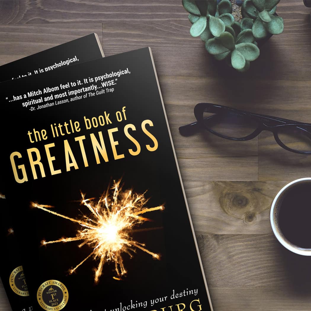 Ari Gunzburg's Little Book of Greatness on a Desktop